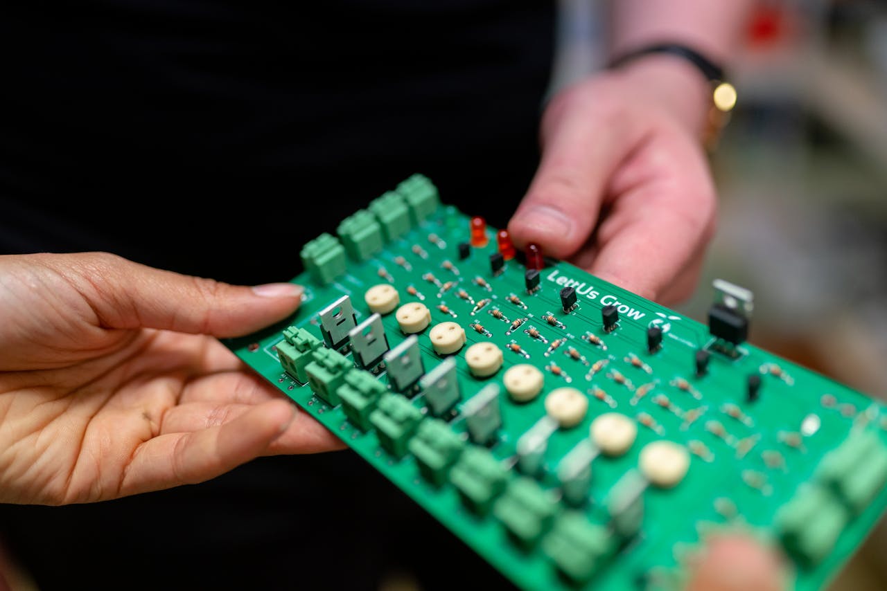Engineers Holding Circuit Board
